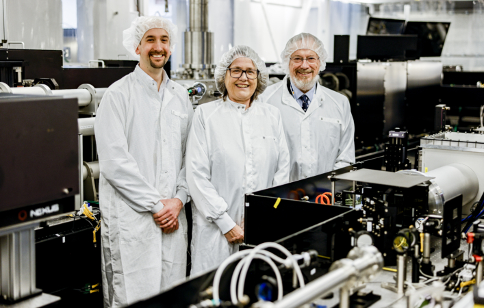 Feature image Three people in protective workwear in a lab