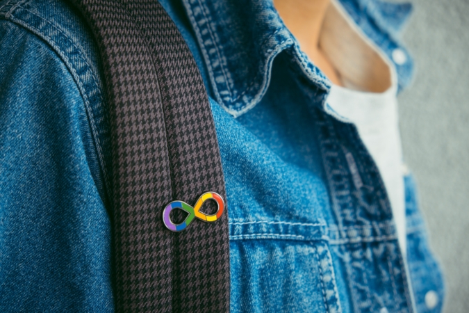 Young boy with autism infinity rainbow symbol sign.