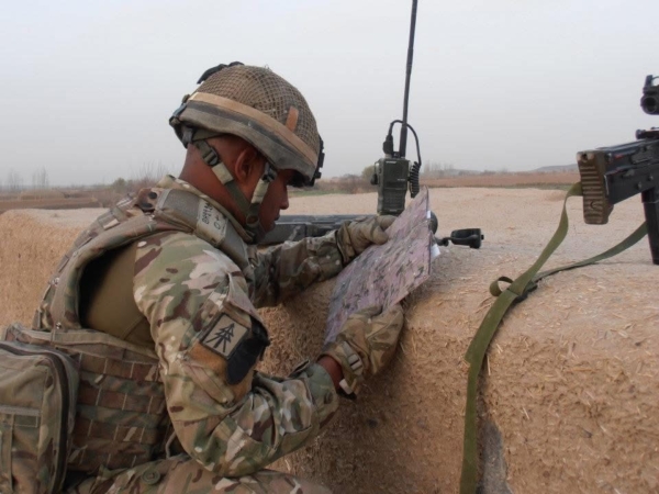Suren looks at instructions while wearing an Army uniform